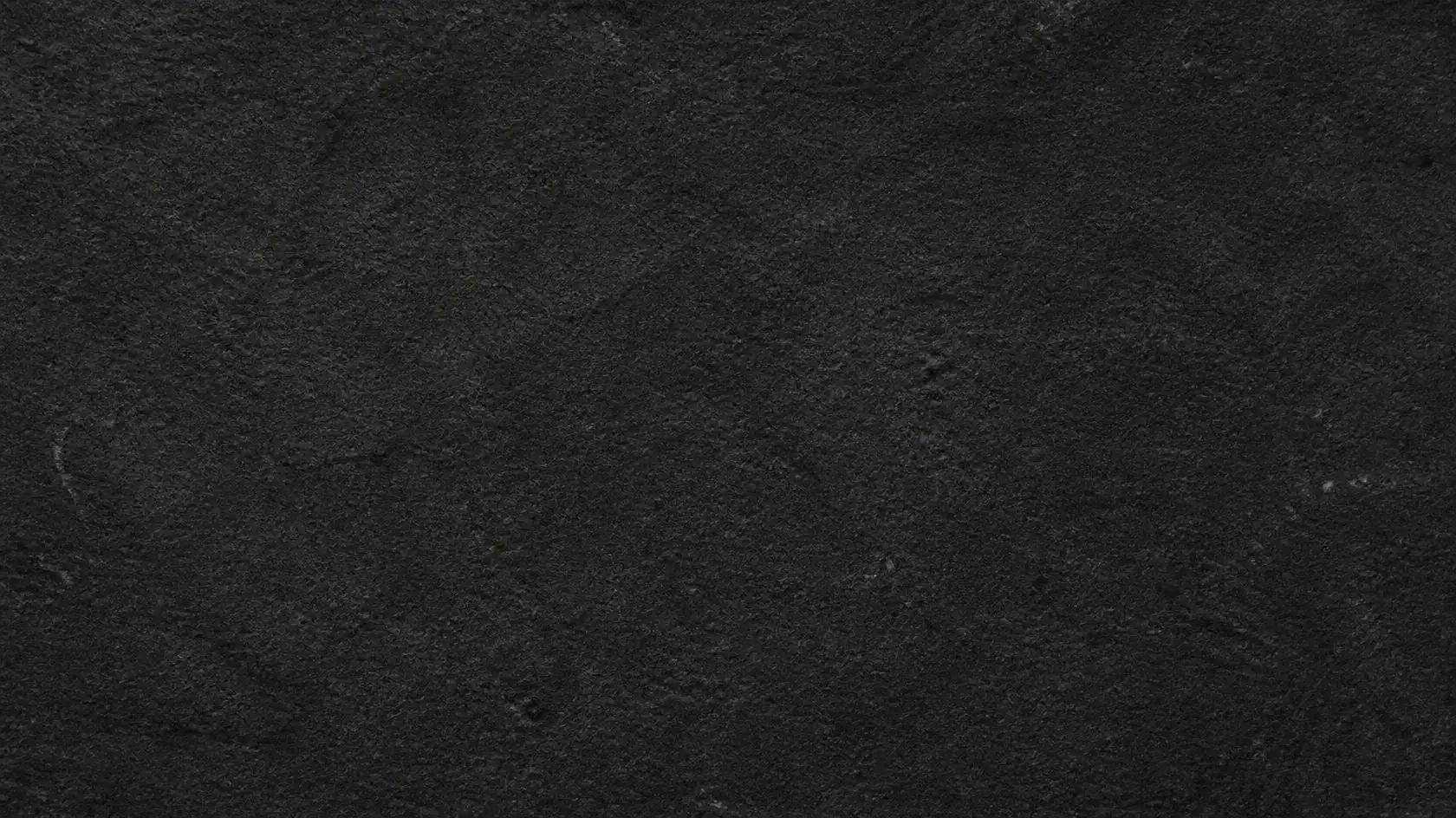 Honed dark stone surface used for carved basins
