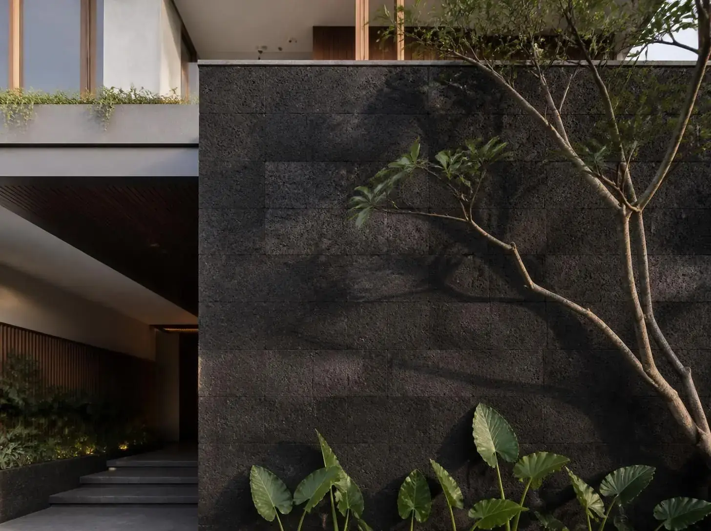 Natural stone facade with tropical planting
