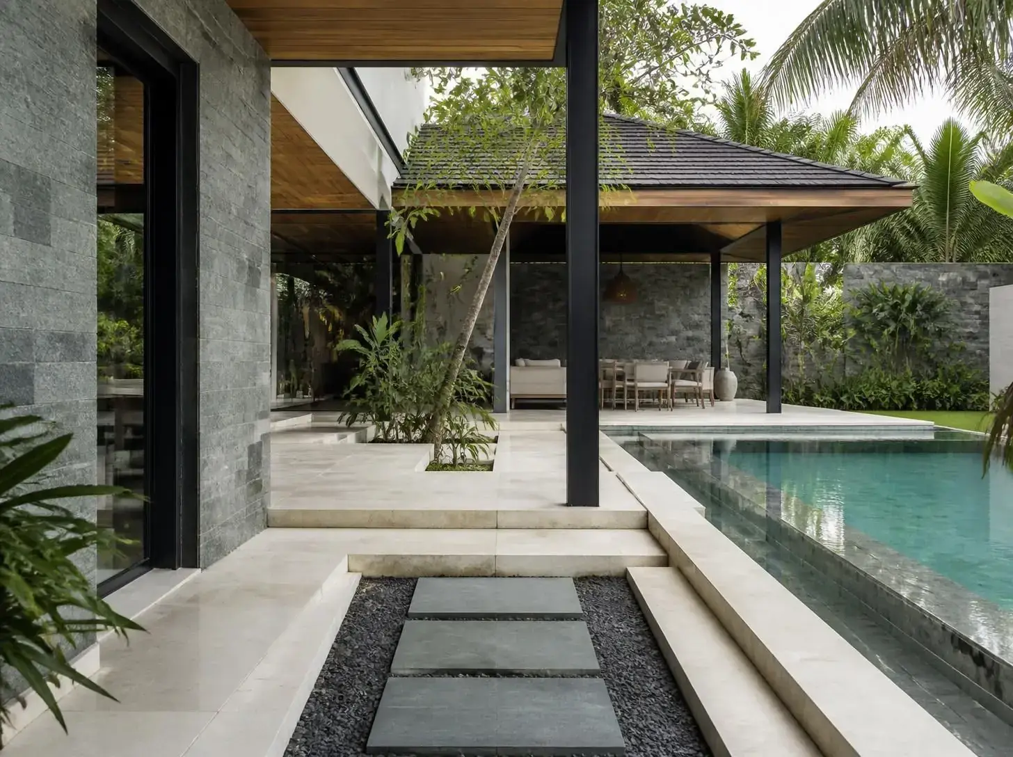 Modern villa swimming pool lined with natural stone tiles